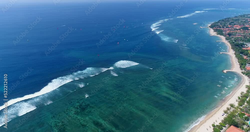 Aerial shot of white sand beach with waves crashing over turquoise water Aerial shot of white sand beach with waves crashing over turquoise water