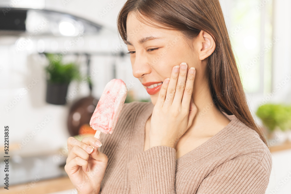 Face expression suffering from sensitive teeth and cold, asian young woman, girl hand touching