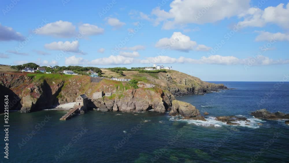 Aerial shot tracking sideways to reveal Lizard Point, lighthouse and coastal cliffs in Cornwall, UK Aerial shot tracking sideways to reveal Lizard Point, lighthouse and coastal cliffs in Cornwall, UK