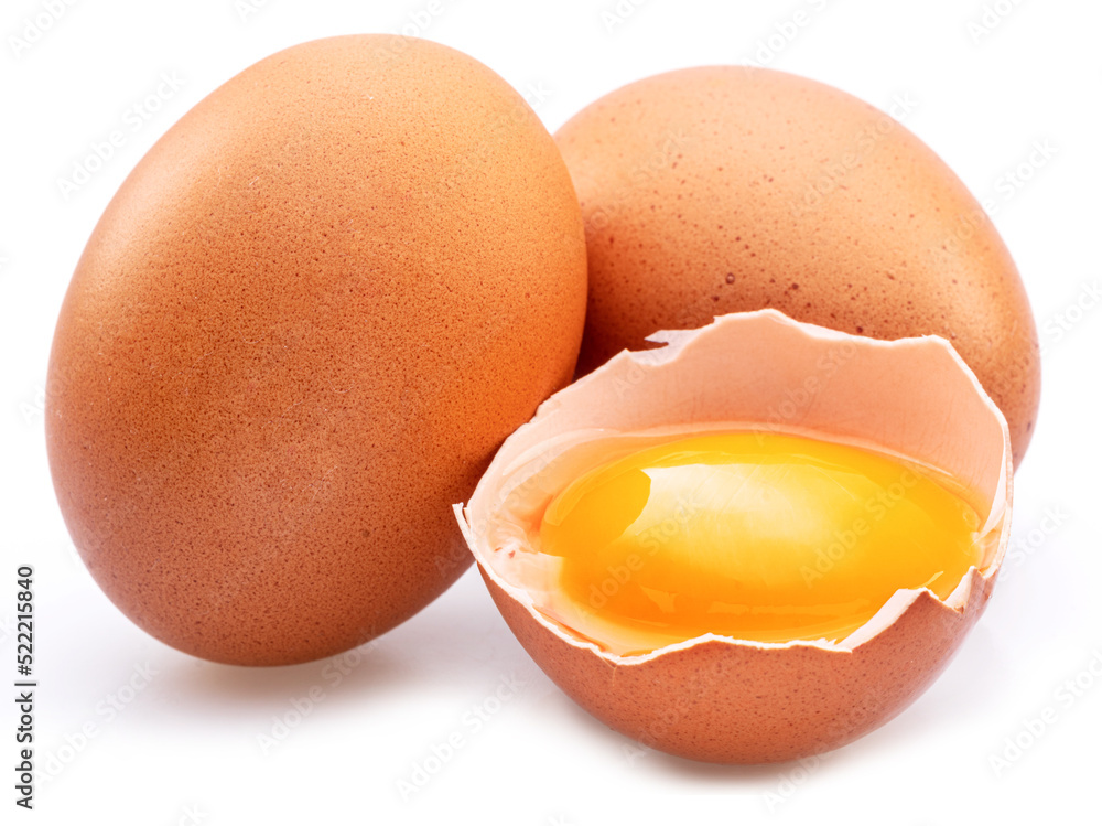Brown chicken eggs and egg yolk isolated on white background.