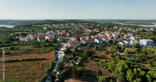 Aerial view around the town of Premantura in sunny Croatia- circling, drone shot photo