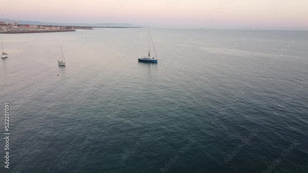 Approaching Sunset boat sailing aerial view near Porto Cavalli. Castiglioncello bay. Livorno, Tuscany. Italy. Summer season. Approaching Sunset boat sailing aerial view near Porto Cavalli. Castiglioncello bay. Livorno, Tuscany. Italy. Summer season.