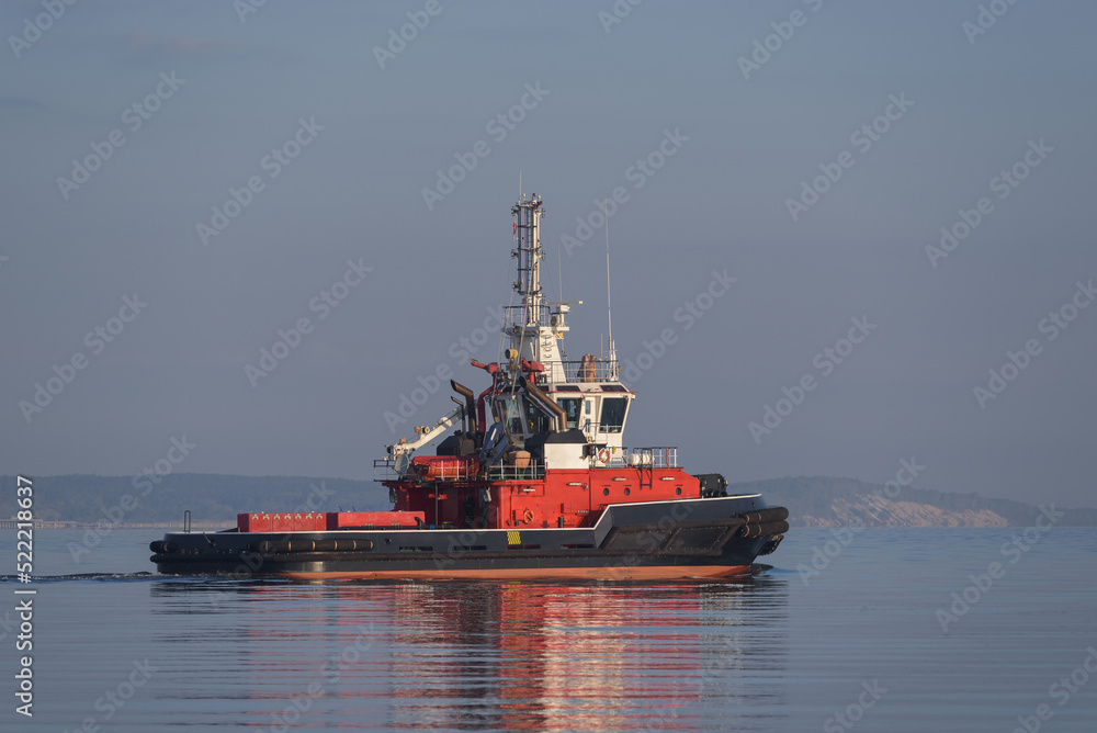 FIREBOAT - Red rescue ship is sailing on the bay FIREBOAT - Red rescue ship is sailing on the bay