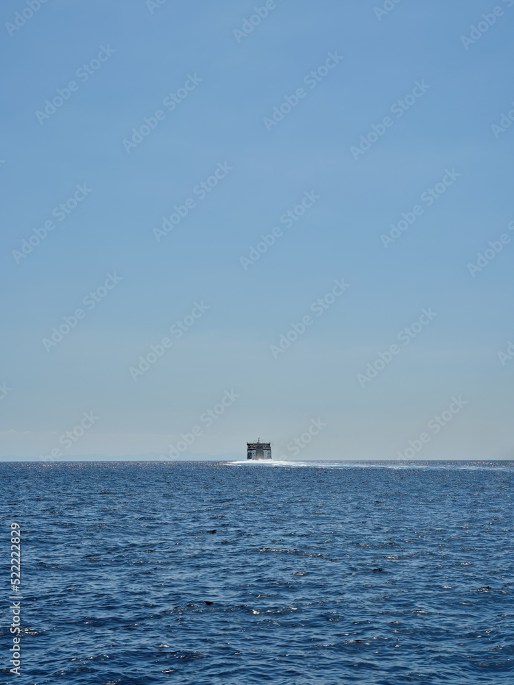 Rear view of a ship at sea on the horizon