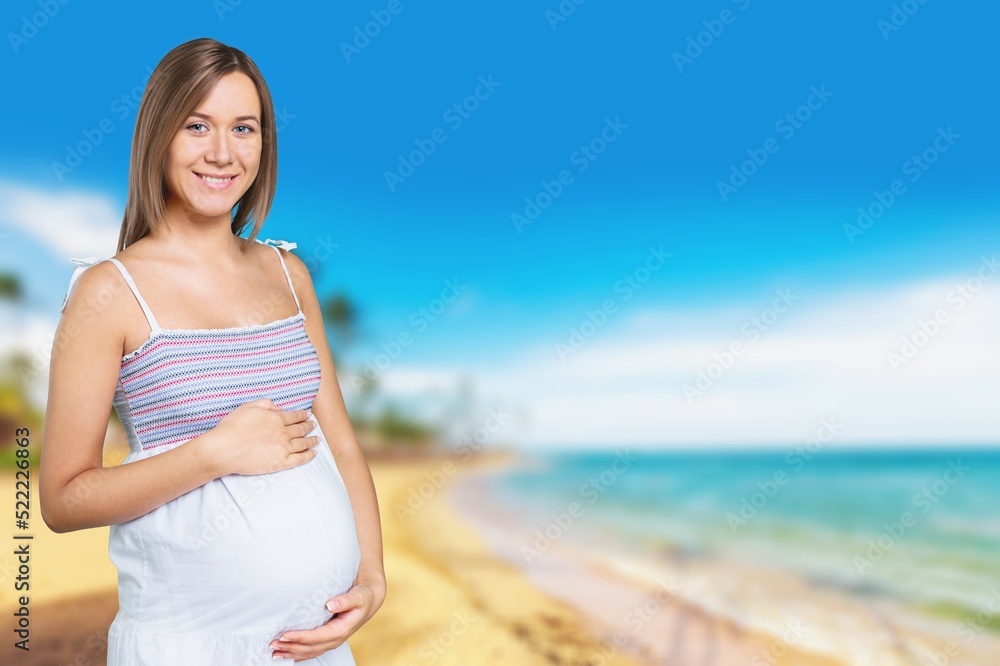 Pregnant woman during spring nature walk. Happy pregnancy outdoors active lifestyle Pregnant woman during spring nature walk. Happy pregnancy outdoors active lifestyle