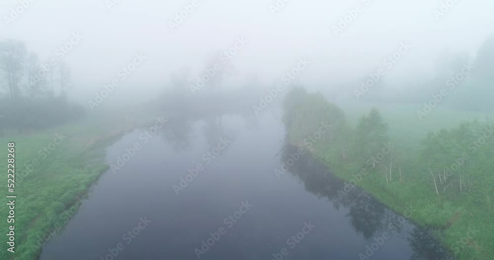 Moving backwards over a misty river in Estonia, Northern Europe Moving backwards over a misty river in Estonia, Northern Europe