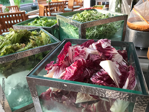 Outstanding glass boxes of variety salad vegetables. photo