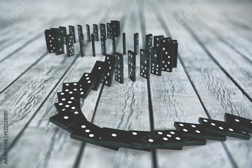 Fotografie Black dominoes chain on a dark table. Domino effect concept