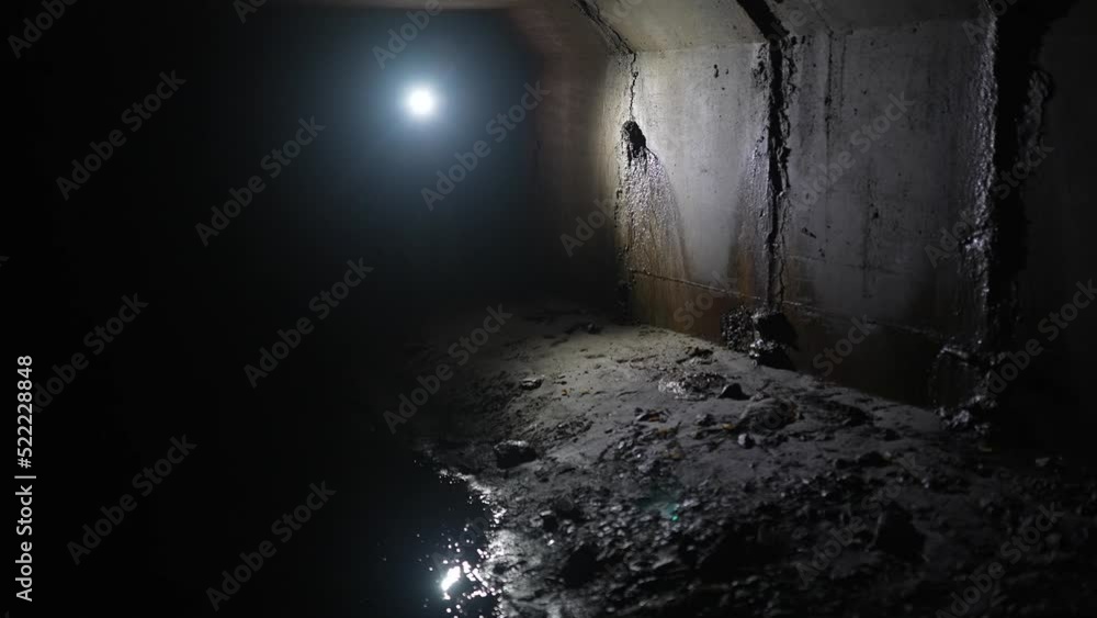 Female digger with flashlight explores the tunnel Female digger with flashlight explores the tunnel