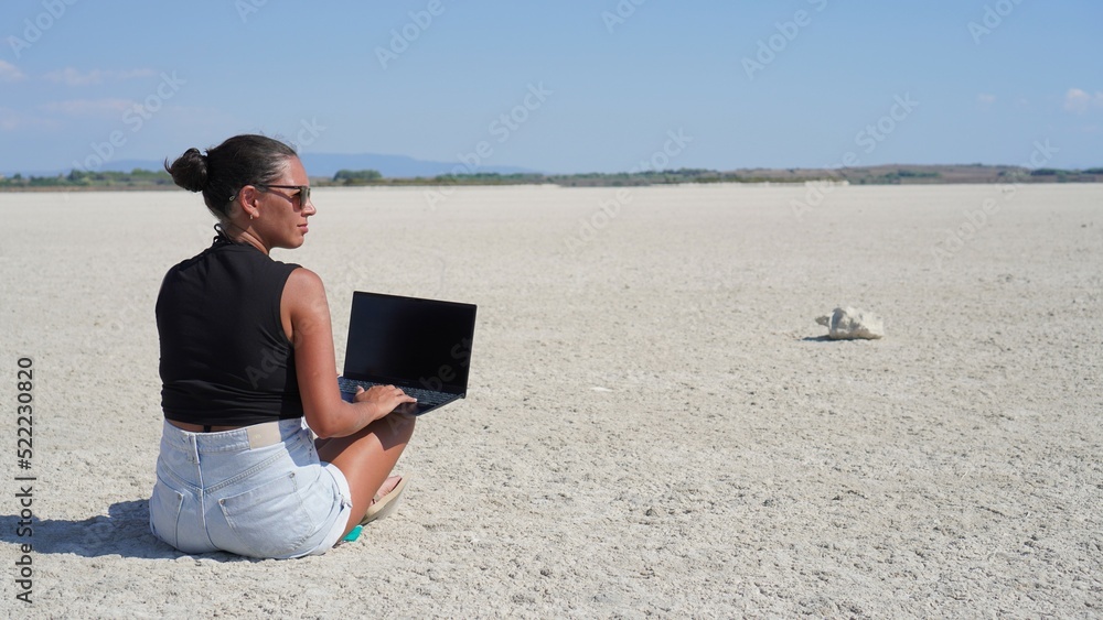 Young digital nomad girl works anywhere in the world thanks to the internet connection and her laptop, new jobs, digital nomad