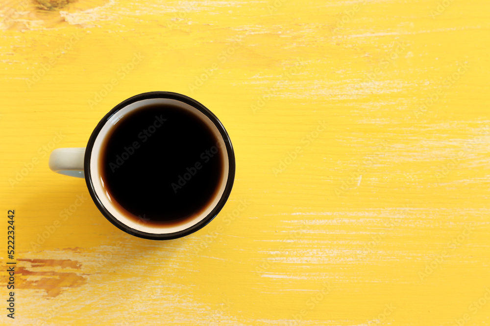Fototapeta premium Top view image of coffee cup over wooden table background.