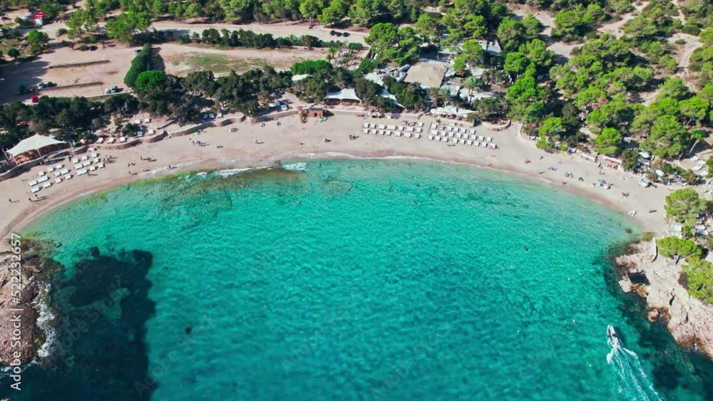 Scenic Aerial view of Cala Bassa Beach Club and resort on Ibiza Island, Spain. Beautiful vacation location with mediterranean sea on the Balearic Islands. Scenic Aerial view of Cala Bassa Beach Club and resort on Ibiza Island, Spain. Beautiful vacation location with mediterranean sea on the Balearic Islands.