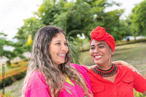 Latin women chatting and having fun in the park photo