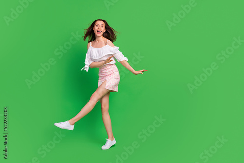 Full size photo of overjoyed positive girl have fun dance clubbing isolated on green color background