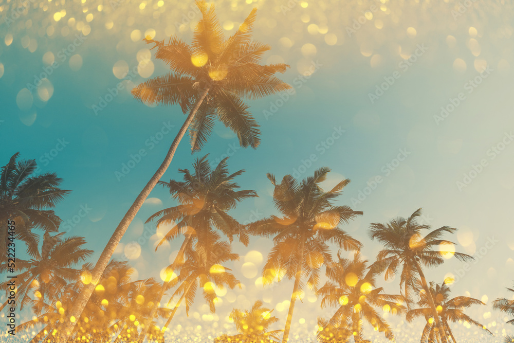 Vintage toned tropical palm trees stylized with shiny golden bokeh overlay