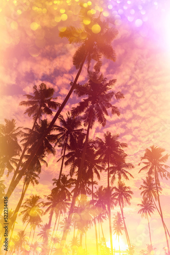 Tropical sunset stylized with vintage film light leaks and golden glitter bokeh