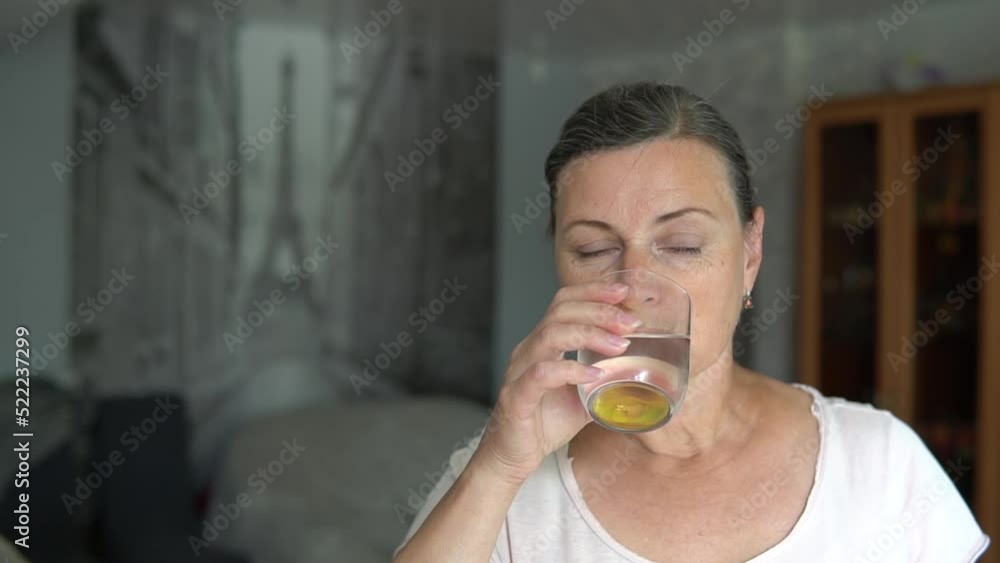 Senior woman taking vitamine supplement, medicine drug pill, drinking capsule with glass of water at home. Health care lifestyle, pharmacy and treatment therapy close up. Senior woman taking vitamine supplement, medicine drug pill, drinking capsule with glass of water at home. Health care lifestyle, pharmacy and treatment therapy close up.