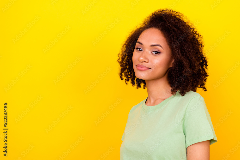 Photo of lovely brunette curly lady near promotion wear t-shirt isolated on bright yellow color background Photo of lovely brunette curly lady near promotion wear t-shirt isolated on bright yellow color background