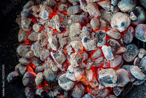 Fototapeta Naklejka Na Ścianę i Meble -  Empty grill with red-hot briquettes, close-up.