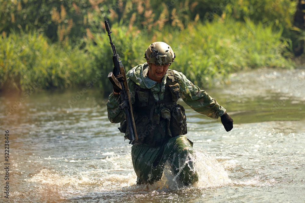 Special forces soldier with weapon take part in military maneuver. War, army, technology and people concept Special forces soldier with weapon take part in military maneuver. War, army, technology and people concept