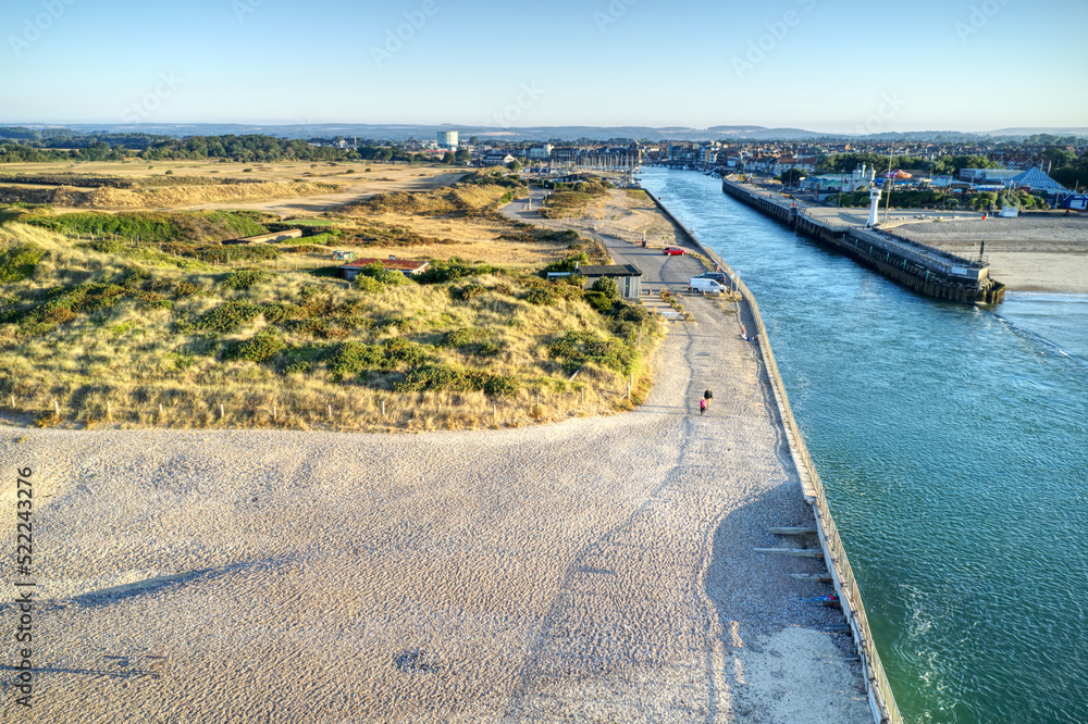 Aerial of the entrance to the River Arun and Littlehampton plus the golf course during the dry and hot summer of 2022 with some fairways dried out from the lack of rain.