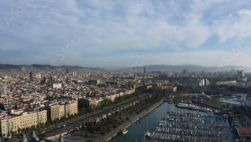 Aerial view overlooking the El Gòtic cityscape and the marina of Barcelona, Spain - circling, drone shot photo