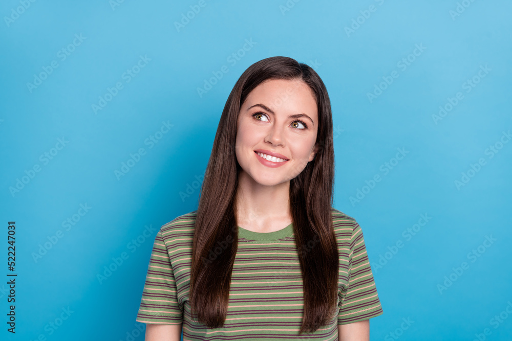 Fototapeta premium Photo of impressed young brunette lady look up wear green t-shirt isolated on blue color background