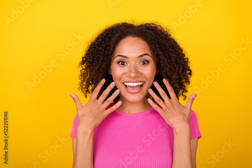 Portrait of astonished cheerful person raise hands showing fingers toothy smile isolated on yellow color background