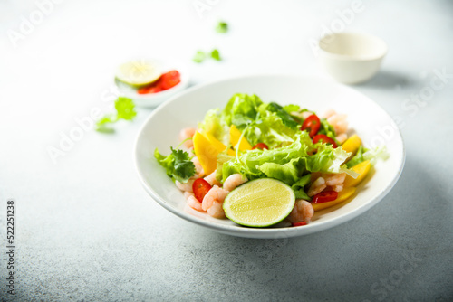 Fresh green salad with shrimps and mango