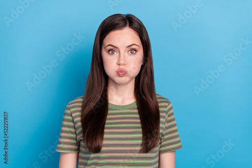 Photo of cute millennial brunette lady hold air wear green t-shirt isolated on blue color background © deagreez