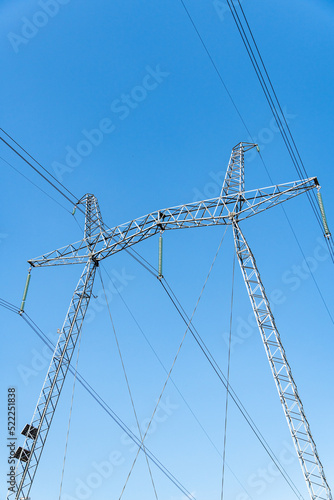Wallpaper Mural Fragment of metal pole of high-voltage power line VL-750 kV against blue sky. Close-up. There are more than 20 insulators in garland. Garlands of insulators are made of glass. Torontodigital.ca