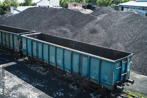 Fototapeta empty railway wagon for transportation of coal and coal halide in sunny day
