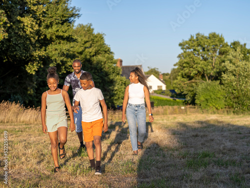 Family with children (8-9, 10-11) walking in countryside © Cultura Creative