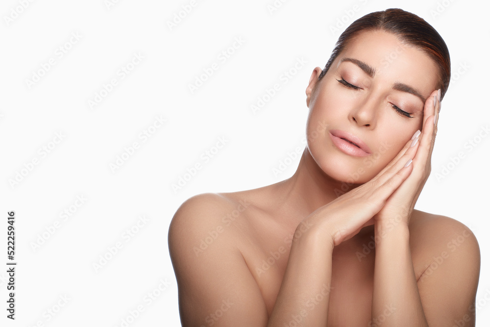 Sensual serene woman with luminous skin wearing nude makeup Sensual serene woman with luminous skin wearing nude makeup
