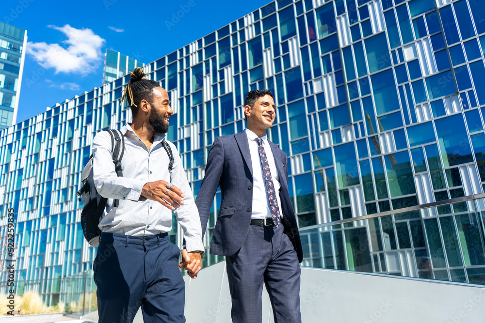 Businessmen couple holding hands in business district Stock Photo ...