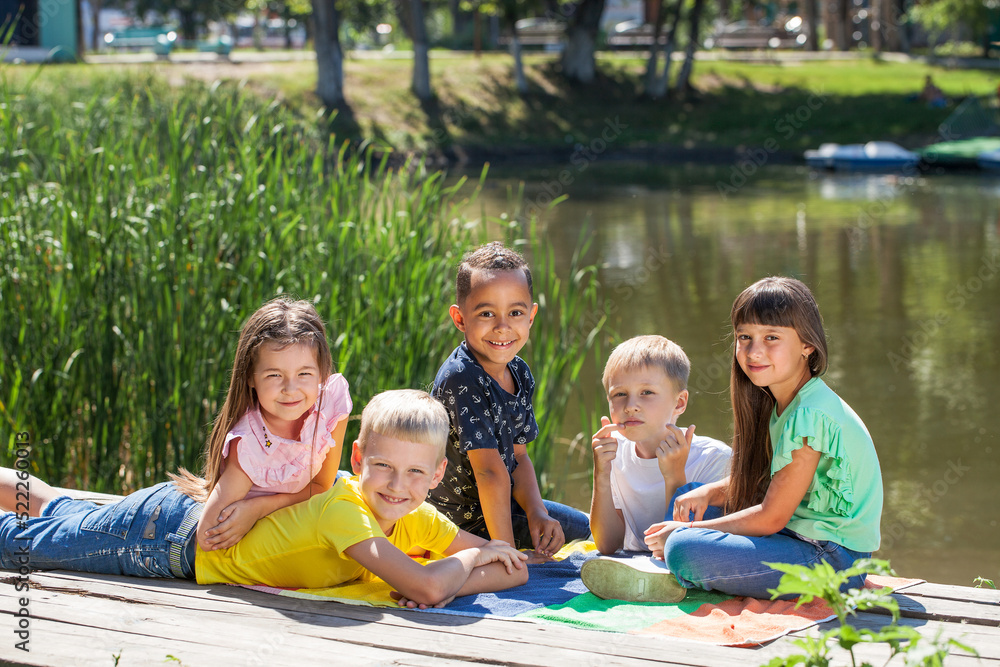 Fototapeta premium Five preschool children posing in a summer park