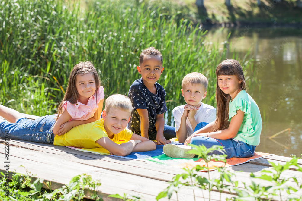 Fototapeta premium Five preschool children posing in a summer park
