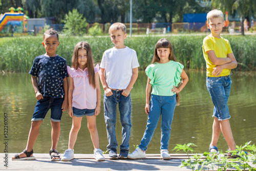Fototapeta Naklejka Na Ścianę i Meble -  Five preschool children posing in a summer park