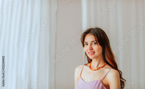 Beautiful long haired young woman on white background with copy space. © Liudmila