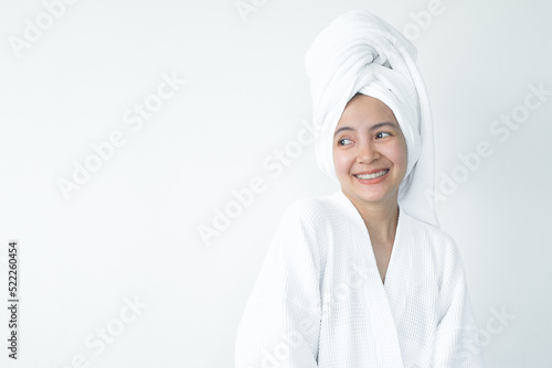 Beautiful Asian woman wearing bathrobe on white background, Face care, Skin care, Facial treatment, Cosmetology, beauty and spa Concept.