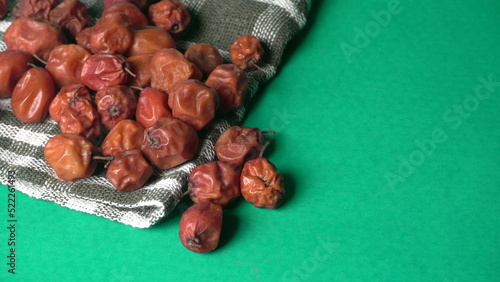 Indian jujube or ber or berry grown in the wild or jungle. Closeup of India fruit on beautiful background. photo