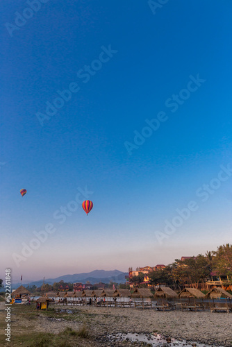 A hot air balloon floats over Vang Vieng Province, Laos.