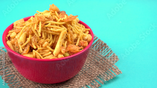 Indian Snacks, Traditional Indian deep fried salty dish called chivda or mixture or farsan made of gram flour and mixed with dry fruits and roasted nuts with salt, pepper, pulses, spice and green peas photo