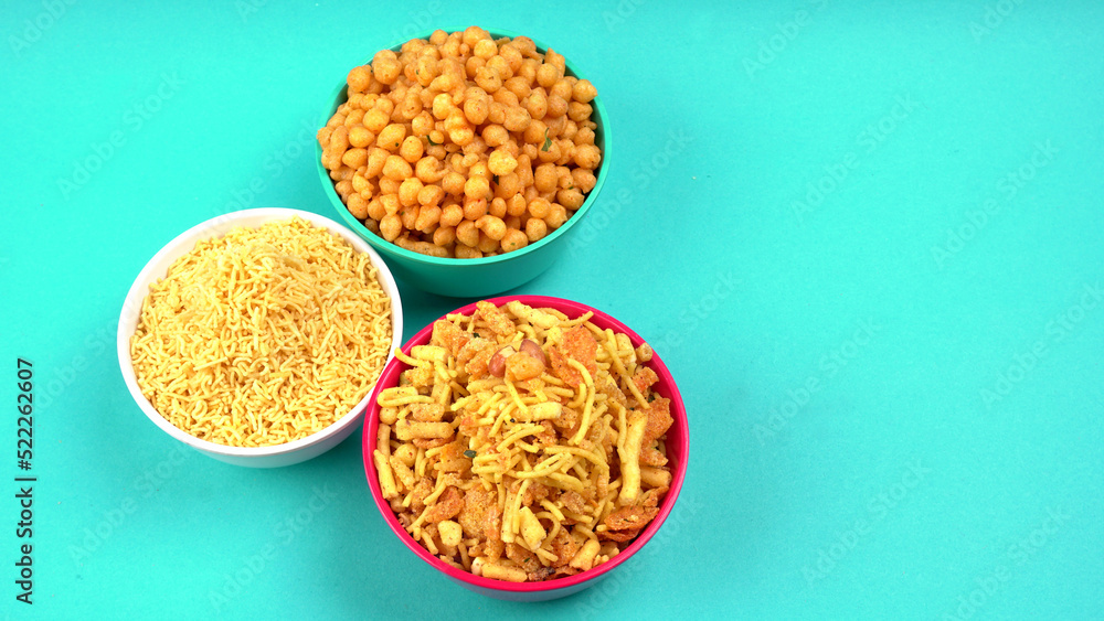 Indian Snacks, Traditional Indian deep fried salty dish called chivda or mixture or farsan made of gram flour and mixed with dry fruits and roasted nuts with salt, pepper, pulses, spice and green peas Indian Snacks, Traditional Indian deep fried salty dish called chivda or mixture or farsan made of gram flour and mixed with dry fruits and roasted nuts with salt, pepper, pulses, spice and green peas