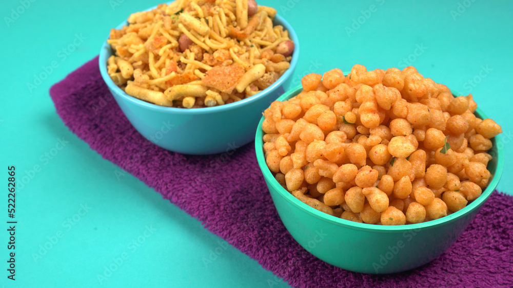Indian Snacks, Traditional Indian deep fried salty dish called chivda or mixture or farsan made of gram flour and mixed with dry fruits and roasted nuts with salt, pepper, pulses, spice and green peas Indian Snacks, Traditional Indian deep fried salty dish called chivda or mixture or farsan made of gram flour and mixed with dry fruits and roasted nuts with salt, pepper, pulses, spice and green peas