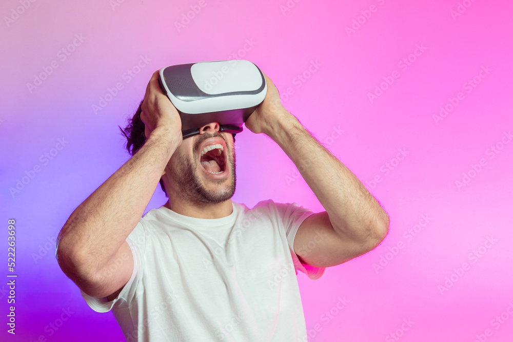 Cheerful man in VR glasses celebrating success Cheerful man in VR glasses celebrating success