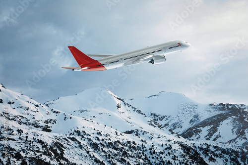 Commercial plane flying over the snowy mountains photo