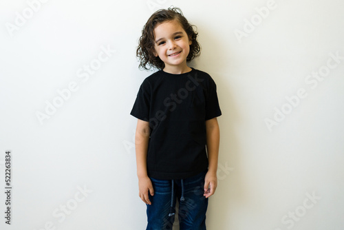 Happy little boy posing with a casual mockup t-shirt