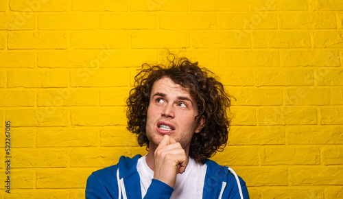 Worried man rubbing chin and thinking