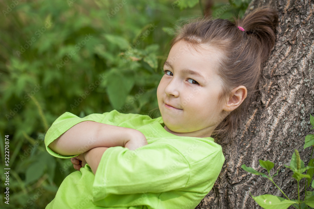 young beautiful preschool girl in a summer park young beautiful preschool girl in a summer park